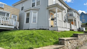 A two-story house with a front porch and a small balcony. - Large Backyard Oasis near River and Trails (Bridgewater)