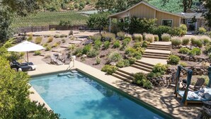 A swimming pool with lounge chairs and a covered patio area. - Oak & Vine: Pool | Hot Tub | Fire Table | BBQ (Glen Ellen)