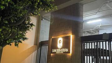 A building entrance with a sign reading "SANSEBASTIAN RESIDENCIAL CONDOMINIUM".
