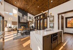 A spacious kitchen with a large island, wooden ceiling, and modern appliances. - Infinity Ridge: Elevated Pool Escape w/ Epic Views • Hot-Tub • Fire-Pit • Games (Epworth)