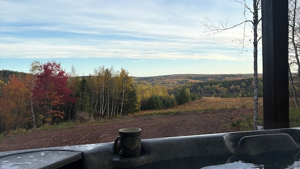 A hot tub with a view of autumn foliage and a distant landscape. - Secluded Mountaineee -View Cabin with Hot Tub & Endless Country Sky (Elgin)