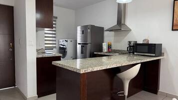 Fridge, microwave, stovetop, coffee/tea maker