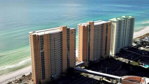 Two high-rise buildings with a beach and ocean in the background. - Splash! Kids Aqua park, Free rental chairs! (Panama City Beach)