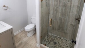 A bathroom with a glass-enclosed shower, a toilet, and a sink. - Passing through/visiting family/doing business &need your own space? Stay Here! (Breckenridge)