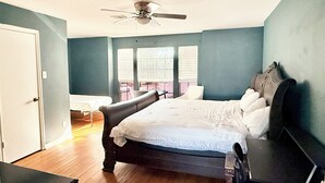 A bedroom with a bed, a ceiling fan, a desk, and a chair. - Family Retreat Near Kalahari-Sleeps 11 (Round Rock)