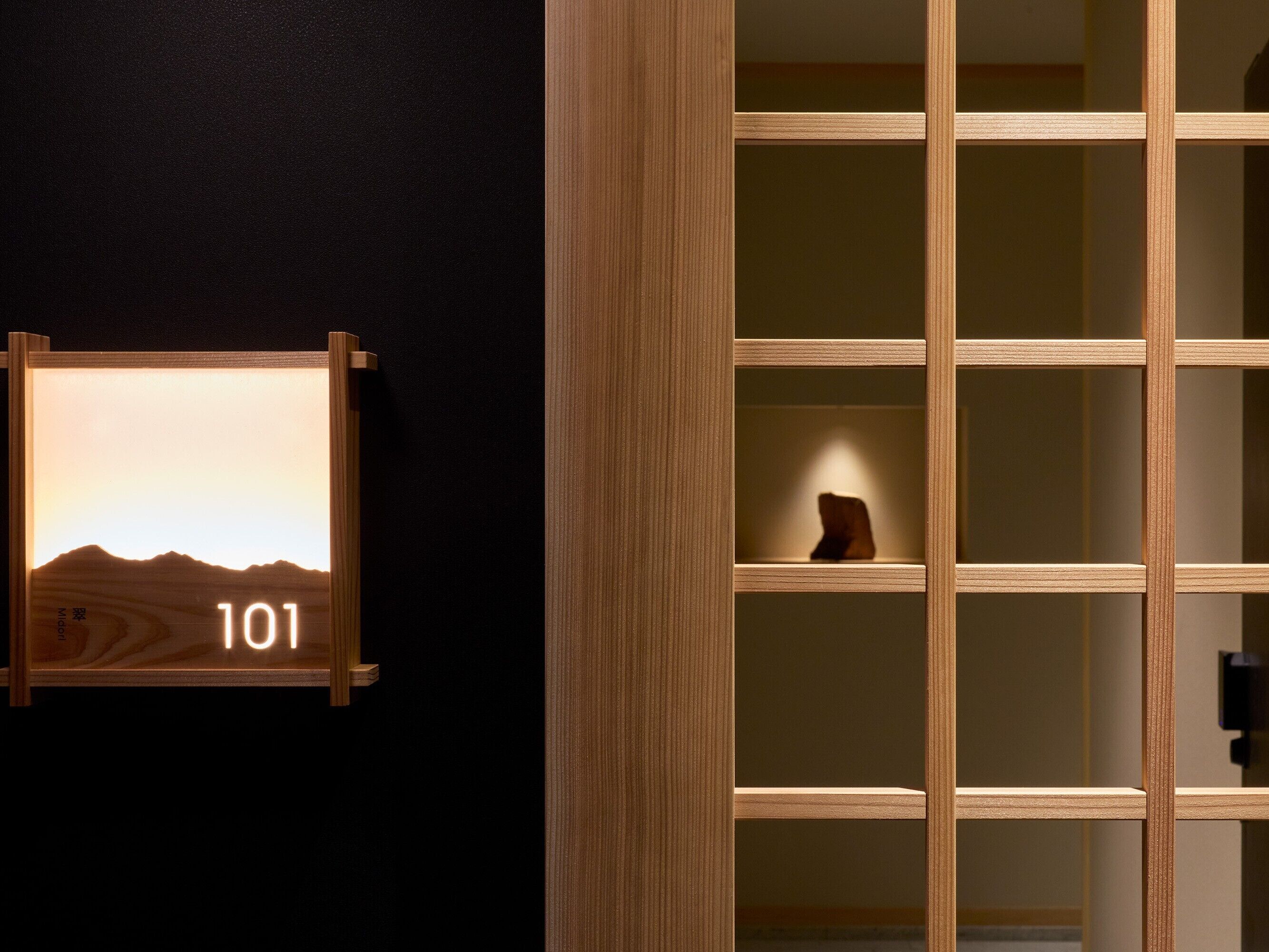 A wooden-framed display with a number '101' and a landscape image.