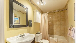 A bathroom with a sink, toilet, and bathtub.