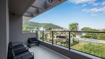 Un balcón con vistas a un paisaje urbano y colinas.