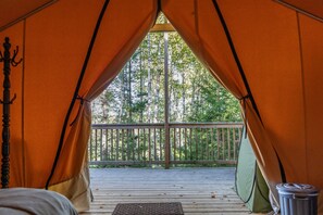 A tent with a wooden deck and a view of trees. - Safari Glamping Tent! Forest Retreat & Hot Tubs! (Bocabec)