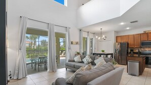 A modern kitchen with wooden cabinets and a stainless steel refrigerator. - Family Paradise - Theatre + Resort + Pet Friendly (Davenport)