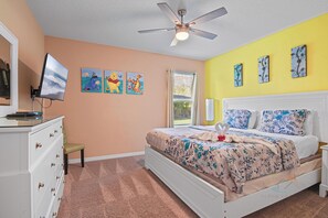 A bedroom with a bed, a dresser, a television, and artwork on the wall. - Tranquil Terrace - 10 Mins to Disney! (Kissimmee)