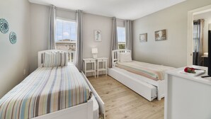A bedroom with two beds, a desk, a chair, and a window with curtains. - Sunset Arcade - Large Pool/spa + Luxe Resort +pets (Davenport)