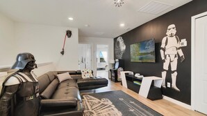 A modern living room with a Star Wars-themed decoration, including a Stormtrooper cutout and a Darth Vader figure. - Golden Getaway - Luxe Resort, Games & Views (Davenport)