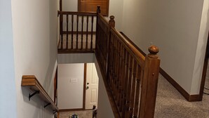 A staircase with wooden railings and a carpeted landing. -  4-bedroom house in Dublin close to ,zoo shopping,restaurant,airport ,5 star (Dublin)