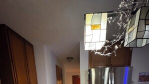 A kitchen with wooden cabinets, a granite countertop, a stainless steel refrigerator, and a wall-mounted calendar. -  4-bedroom house in Dublin close to ,zoo shopping,restaurant,airport ,5 star (Dublin)