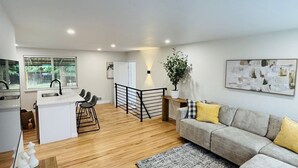 A modern living space with a kitchen, dining area, and seating area. - A Sleek Modern 4-bedroom house with updated amenities in welcoming Westminster (Westminster)