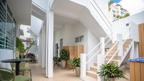 Ein modernes Interieur mit Treppe, Sitzgelegenheit und Topfpflanzen.