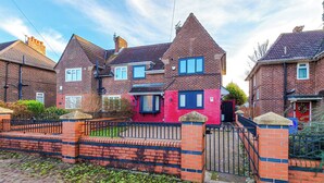 A row of two-story houses with brick facades, a gated driveway, and a clear sky. - Modern 3-Bed - Near Etihad & City Centre (Manchester)