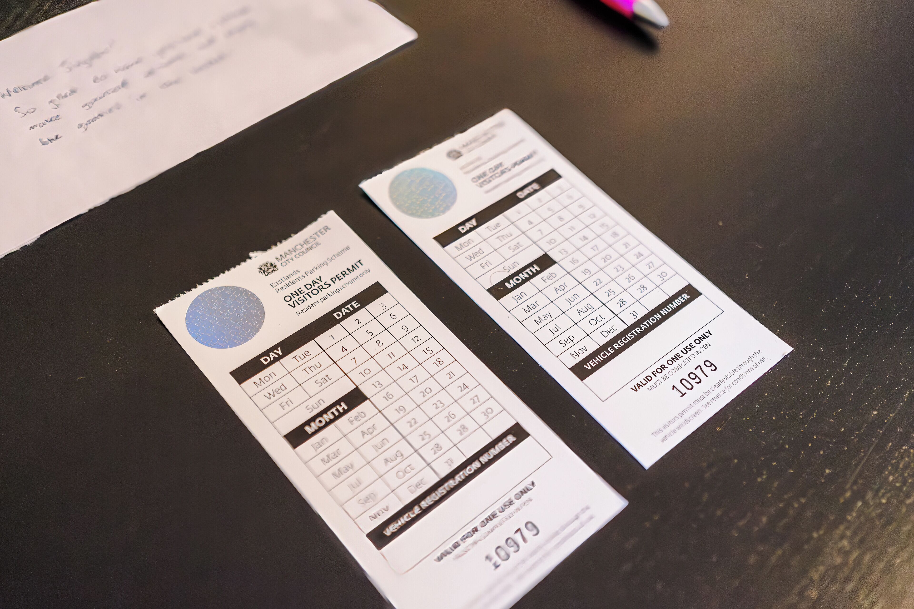 Two parking permits on a table.