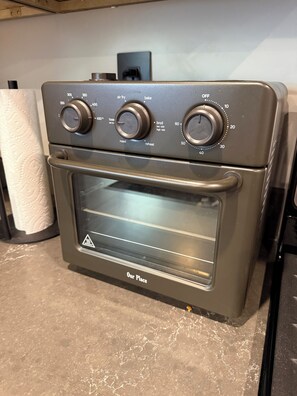 A stainless steel oven with control knobs labeled for various functions like air fry, bake, roast, and broil. - Newly Remodeled A-Frame 5 min drive to Sundance (Sundance)