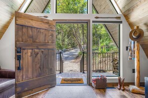 A wooden door leading to a covered outdoor area with a view of a forested landscape. - Newly Remodeled A-Frame 5 min drive to Sundance (Sundance)