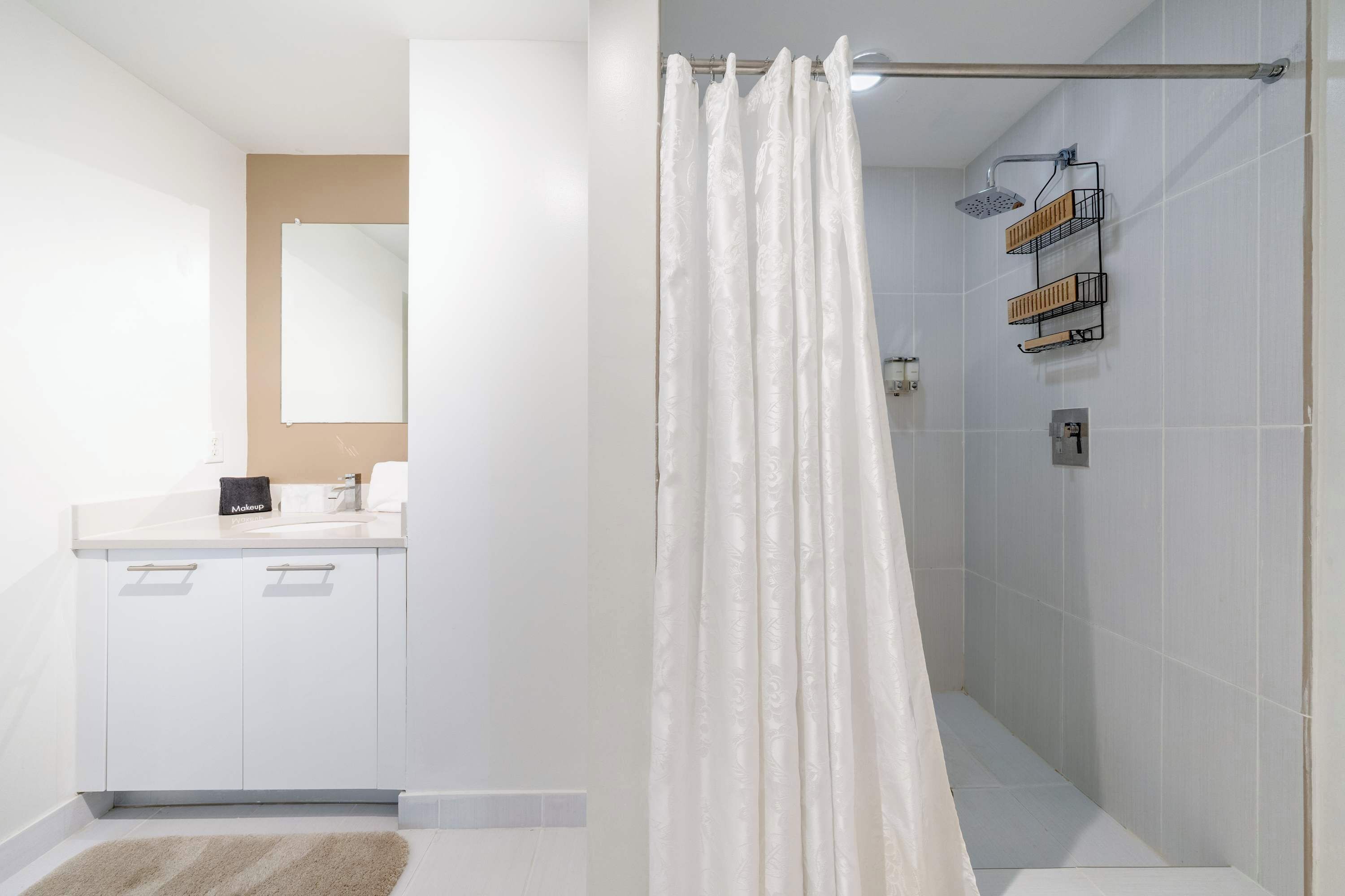 A bathroom with a shower, a toilet, and a sink.