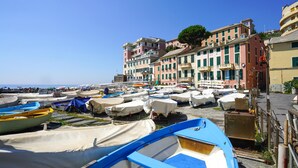 A coastal town with colorful buildings and numerous boats docked along the shore. - 1 bedroom nice apartment in Genova (Genova)
