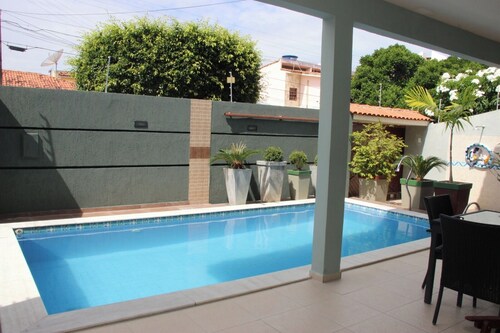 Beautiful mansion with pool, barbecue area, garage, master suite, and hot tub.