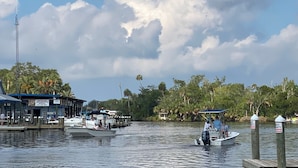 A marina with boats docked, a restaurant named "Michael Anthony's Pizza" on the left, and a sign indicating "Private Property" on the right. - Riverfront 2-bedroom townhome in peaceful Homosassa with AC/Heat, Pool (Homosassa)