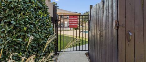 A gated entrance with a sign indicating no trespassing for residents.