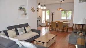 Un soggiorno moderno con divano, tavolino e zona pranzo.
