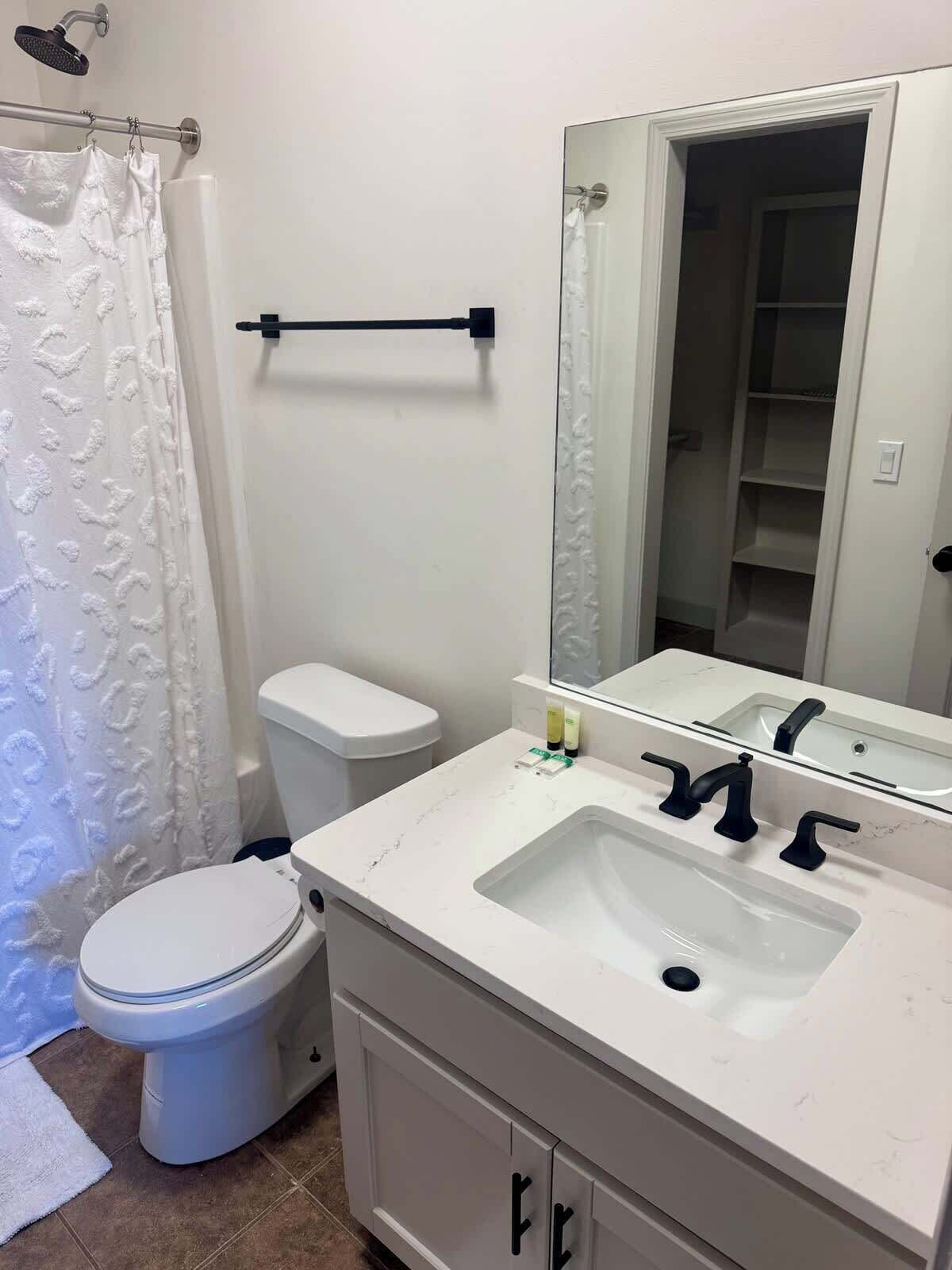 Shower, hair dryer, towels, shampoo