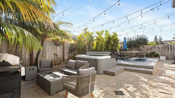 An outdoor patio with a grill, seating area, and a hot tub. - Point Loma Hideaway · Relaxing Hot Tub + AC (San Diego)