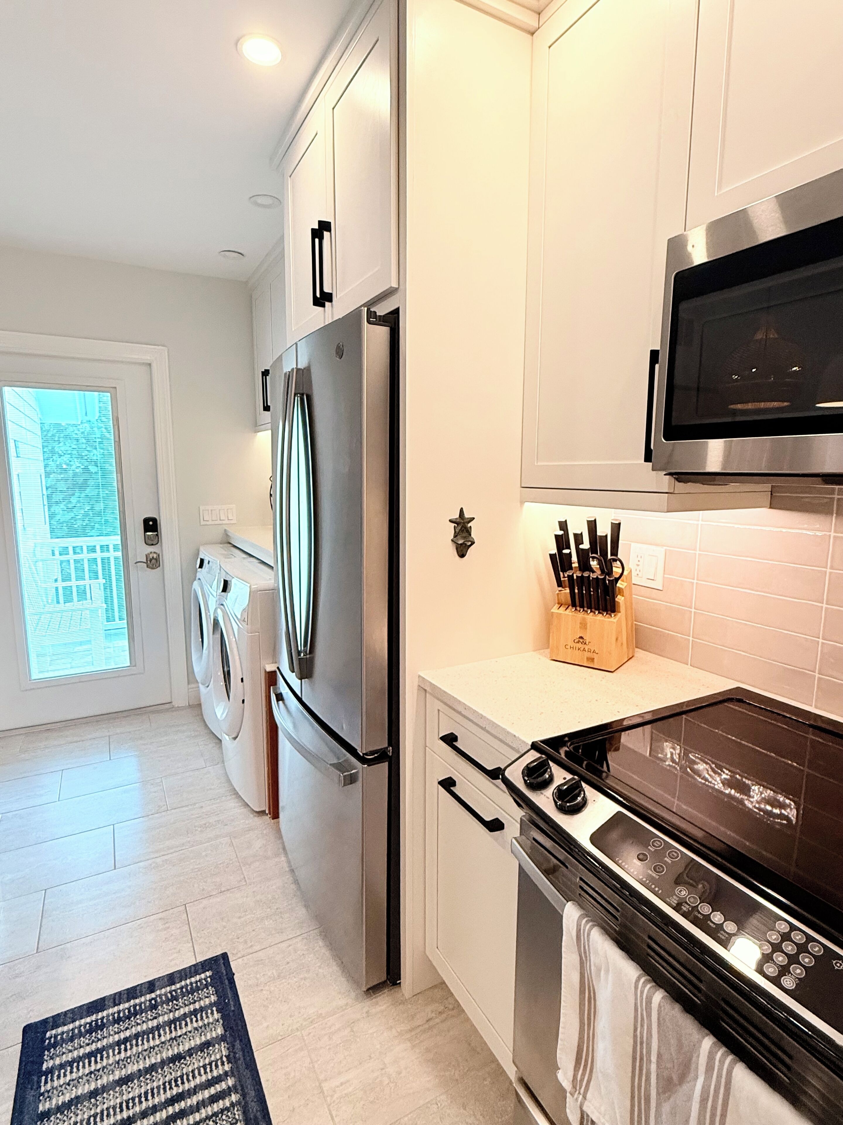 A modern kitchen with stainless steel appliances, a microwave, and a built-in oven.