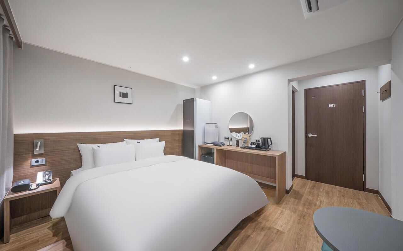 Hypo-allergenic bedding, desk, laptop workspace, blackout curtains