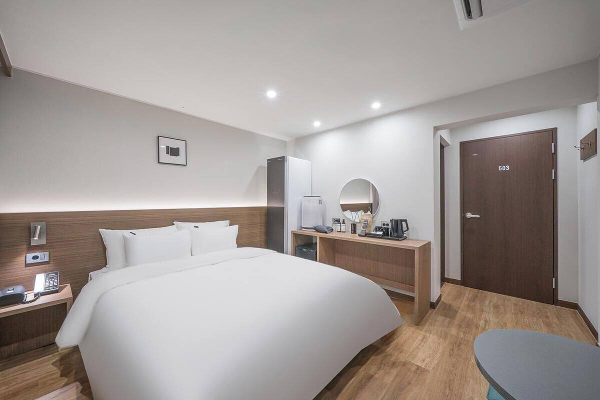 Hypo-allergenic bedding, desk, laptop workspace, blackout curtains