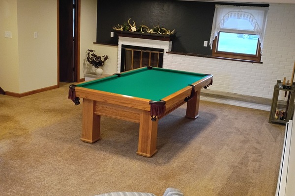 Cozy game room with pool table, fireplace &
swivel chair.