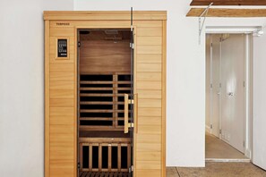 A wooden sauna with a control panel, sliding doors, and a bench inside. - Panoramic Ocean Views | N. Avoca, Sleeps 10 (North Avoca)