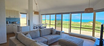 Beachfront retreat with breathtaking views steps from the shore.