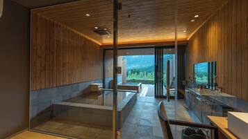 A modern interior with wooden paneling, a glass partition, and a view of a mountainous landscape.