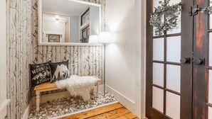 A bathroom with a wooden bench, a mirror, a white sink, and a door with a frosted glass panel. - Ski Oasis w/ Hot Tub near Killington & Woodstock (Bridgewater)