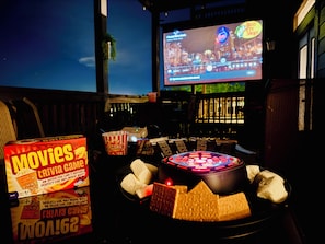 A bar area with a neon sign, popcorn, and a movie trivia game.