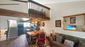 A cozy living area with a dining table, a wooden bench, and a sofa. - Summit Sanctuary of MeadowRidge. Great space and great location! (Fraser)