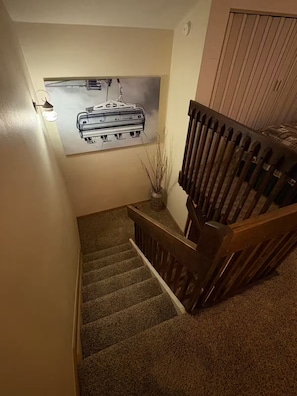 Eine Treppe mit Holzgeländer und Teppichstufen.