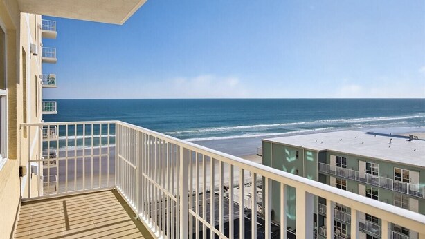 A balcony with a view of the beach and ocean. - Endless Horizon at the Aruba (Daytona Beach)