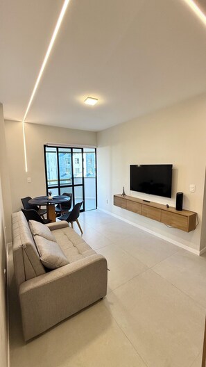 Departamento Confort, vista a la ciudad | Área de sala de estar | Televisión LED de 50 pulgadas con canales digitales 
