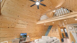 A wooden interior with a ceiling fan, a sofa, a TV, and a staircase. - LAKESIDE DOCKSIDE: Henrys Fork Private Beach Dock Fishing Yellowstone UTV Snowmobile Trails (Island Park)