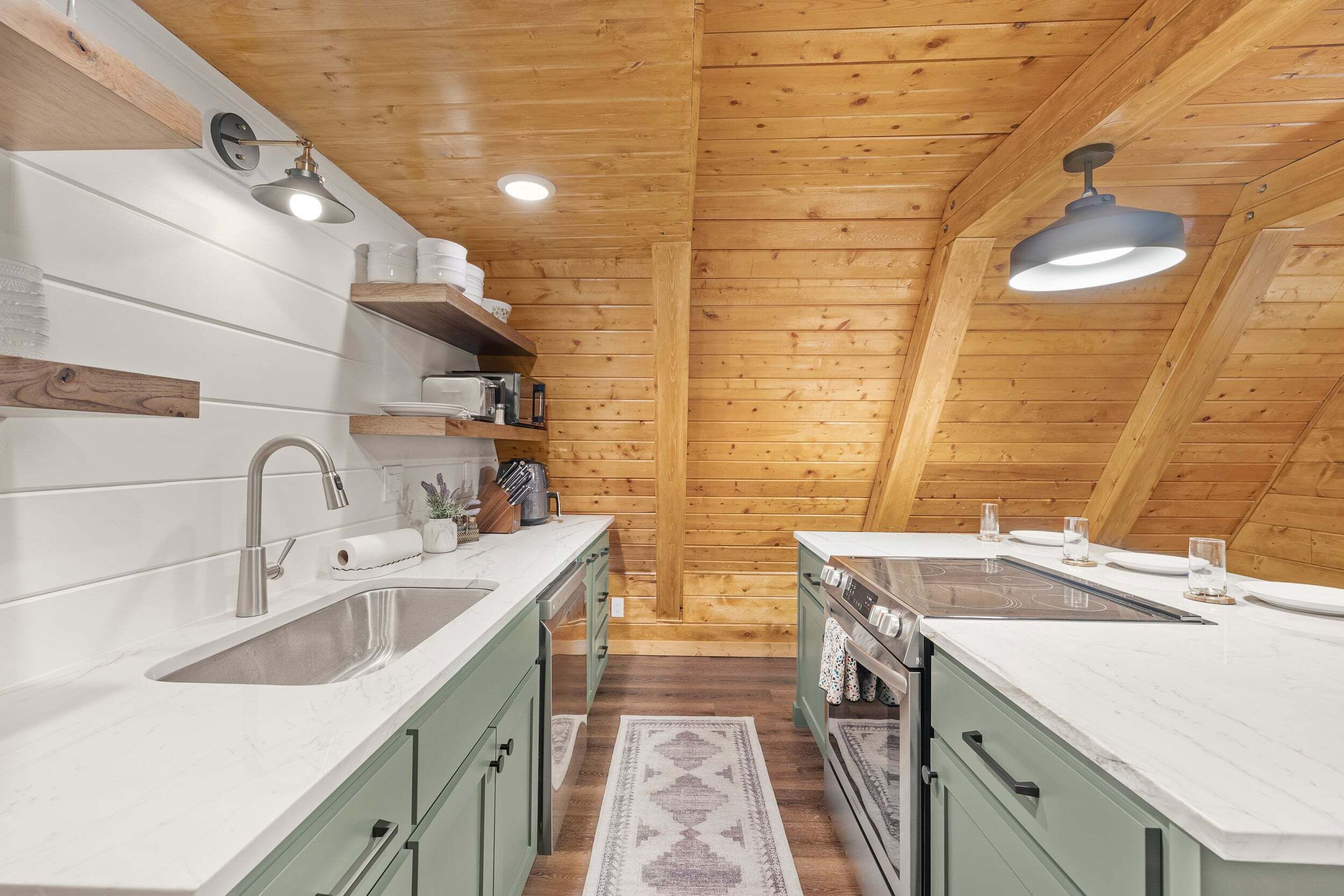 A kitchen with wooden beams, white countertops, and a central island.