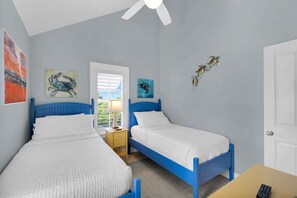 A bedroom with two beds, a ceiling fan, and artwork on the walls. - The Point at Coral Lagoon, Rare End of Canal Villa (Marathon)
