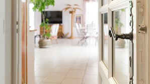 A doorway leading into a room with a tiled floor, a television, and a plant. - Villa with Independent Studio, Pool, Jacuzzi, Playground, Quiet Nature (CHATEAUVERT)